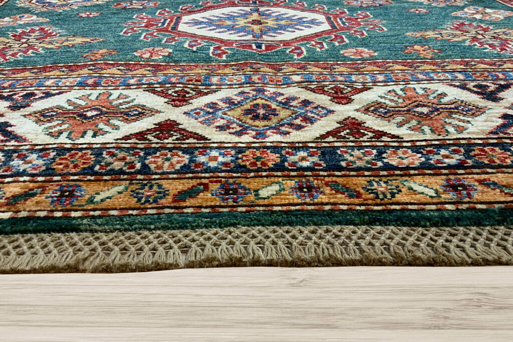 Add this beautiful green Kazak area rug to your living room with David Tiftickjian & Sons.