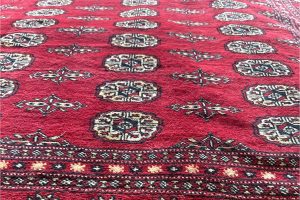 A new red, geometric bokara rug brought in for our 2025 Customer Appreciation Sale.