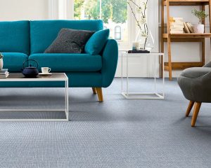 A living room shot with a blue carpet from the 1866 by Masland collection for David Tiftickjian And Son's Masland Carpet Sale!