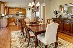 A dining room table on an oriental rug with a kitchen rug visible in the background. Protect your hardwood flooring this Thanksgiving.