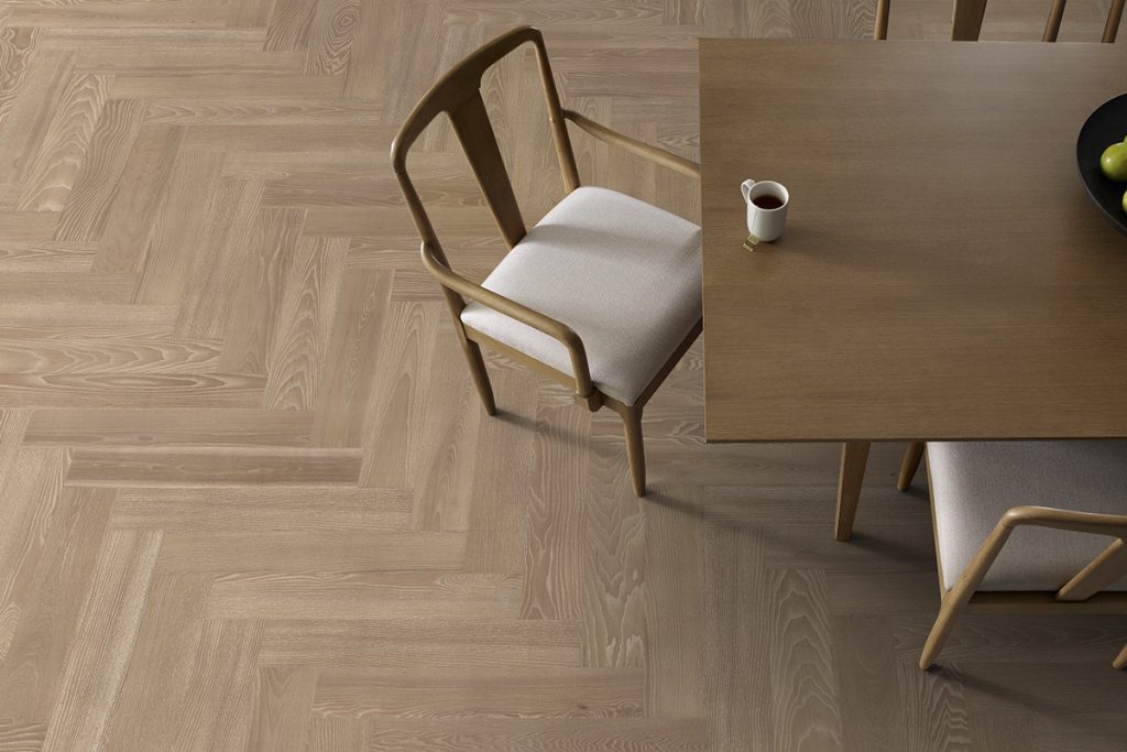 Patterned hardwood flooring like herringbone or chevron is one of the 2026 floor trends that will help enhance your home.