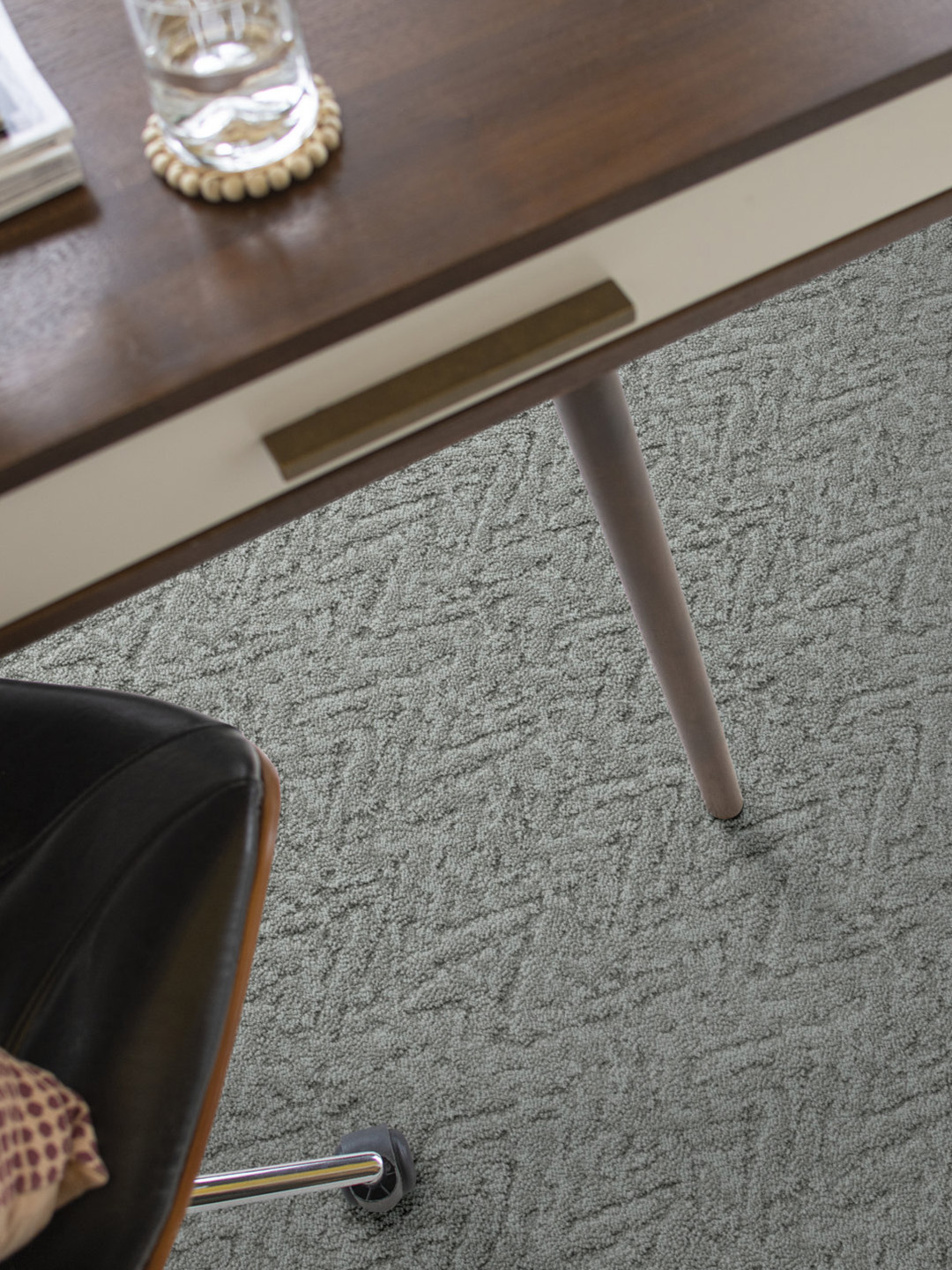 A gray rug beneath a table.