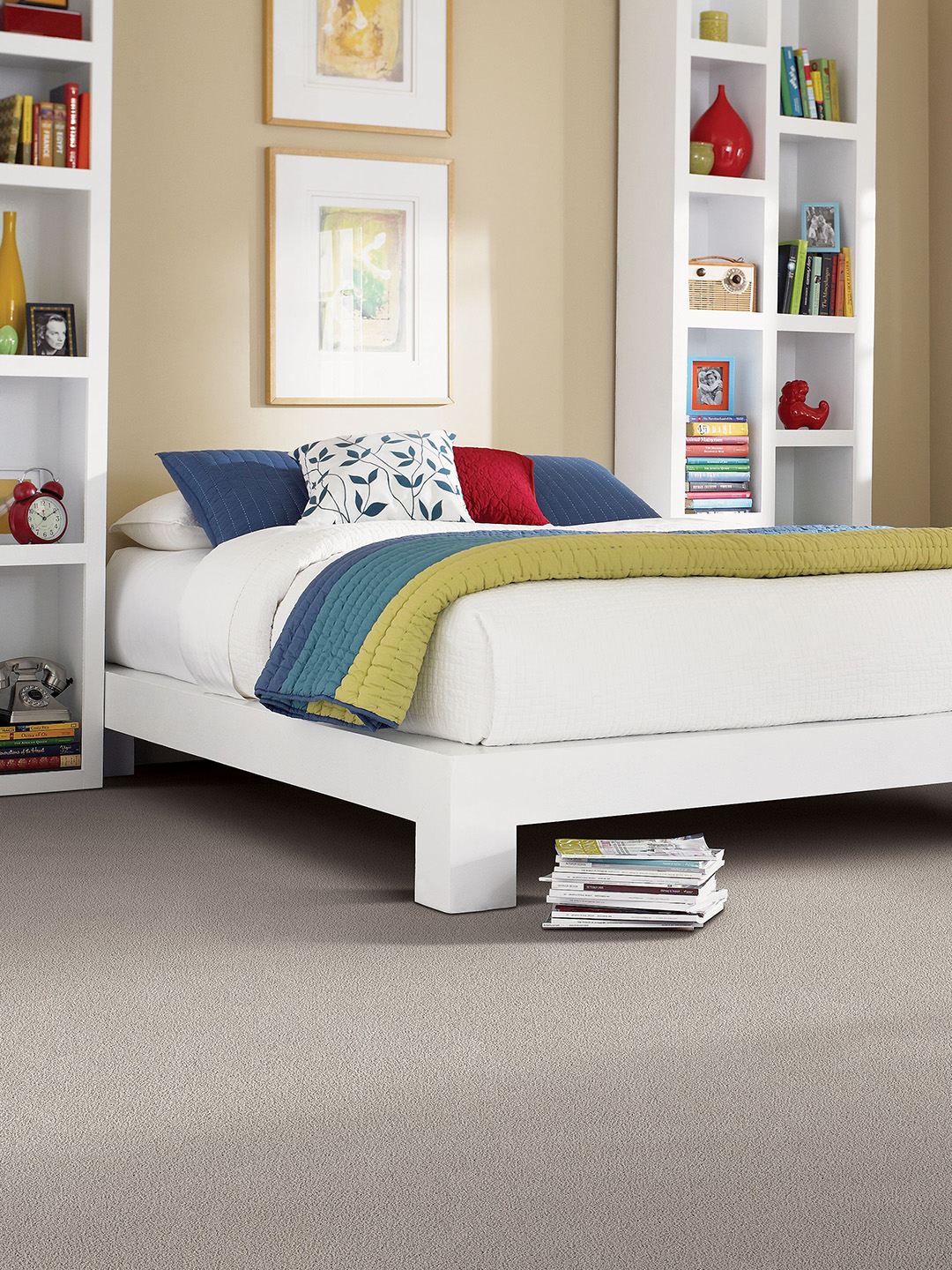 Brown broadloom carpet with a white bed.