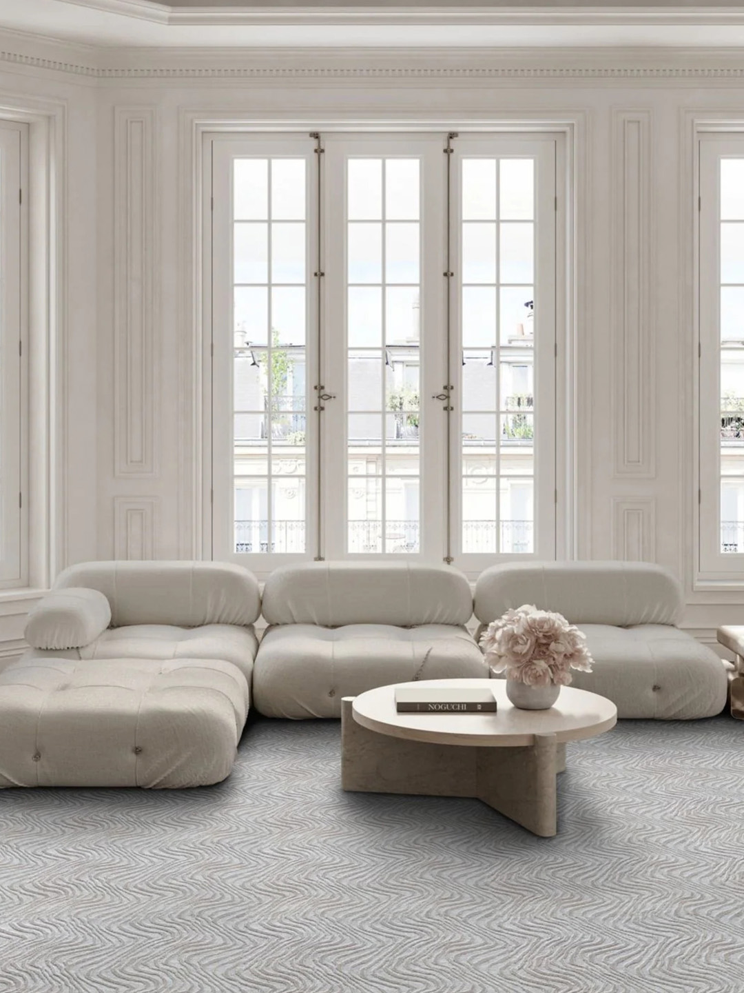 Gray carpet by Prestige Mills under a light colored sofa and coffee table.