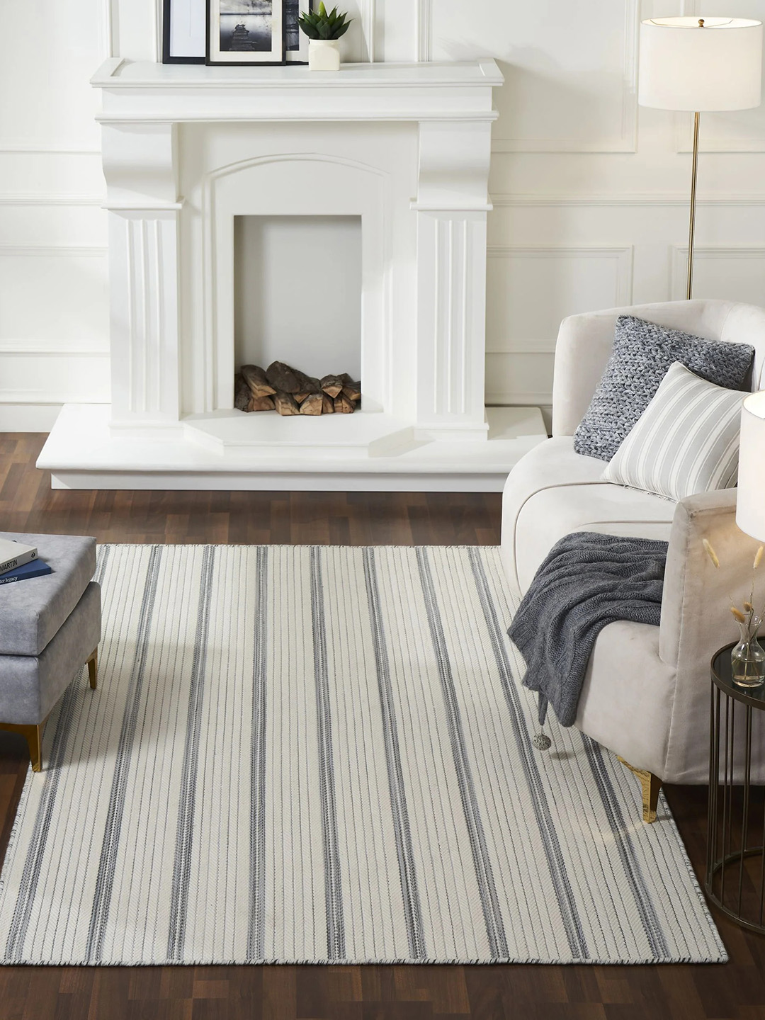 A white and gray striped carpet by Prestige Mills in front of a white fireplace.