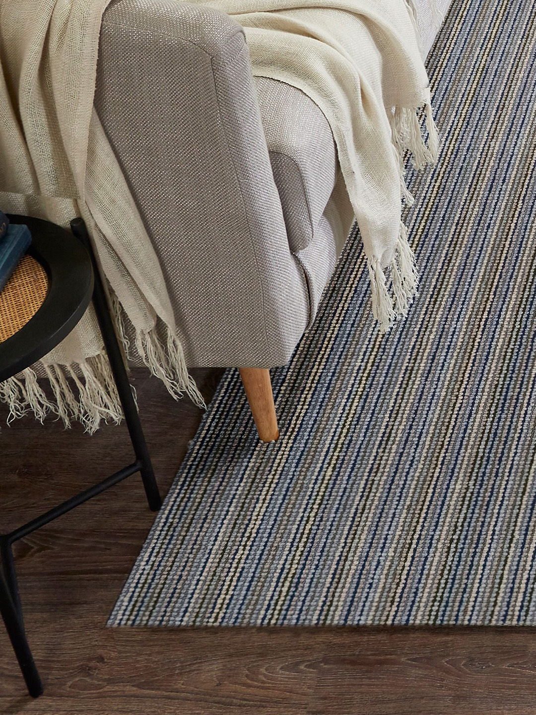 A multicolored carpet by Prestige Mills under a gray chair.