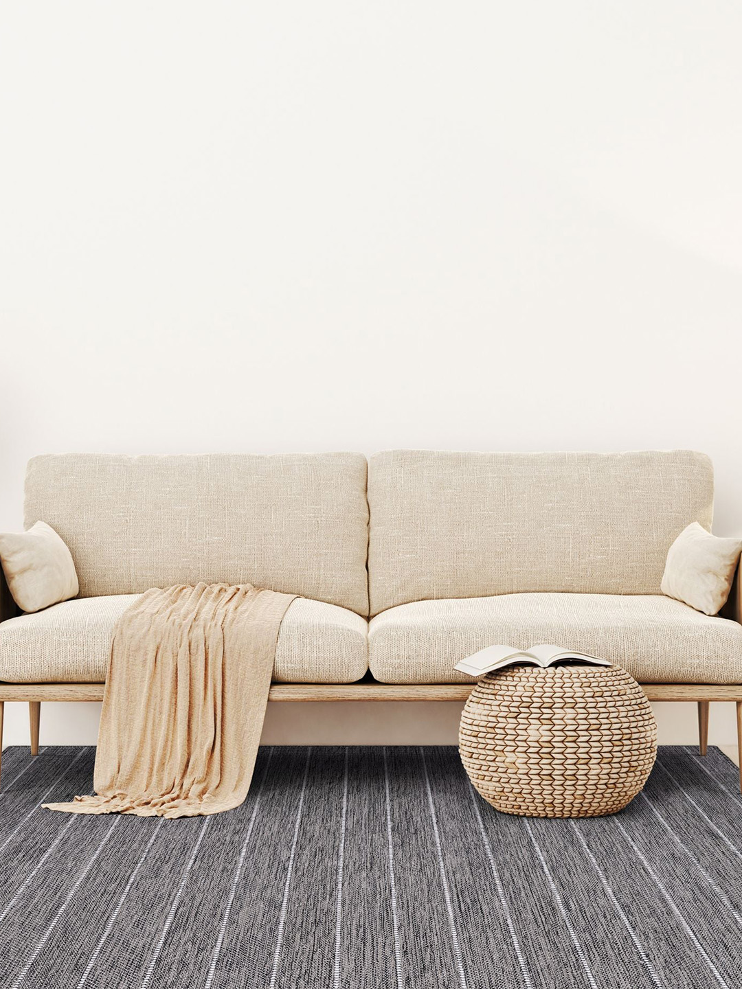 A dark gray striped carpet by Prestige Mills under a beige couch.