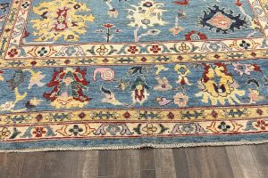 Veggie dyed rug with a blue base featuring multiple colors and a traditional design.