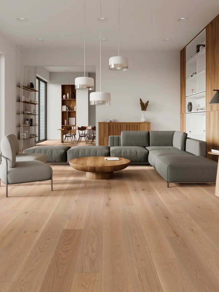 Light warm colored hardwood floor with gray furniture and a living room scene.