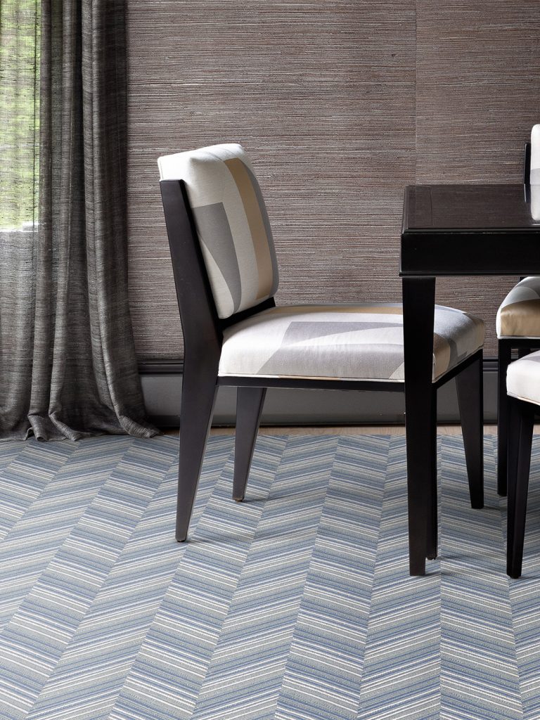 A blue patterned carpet with dark wood furniture for our spring carpet inspo.