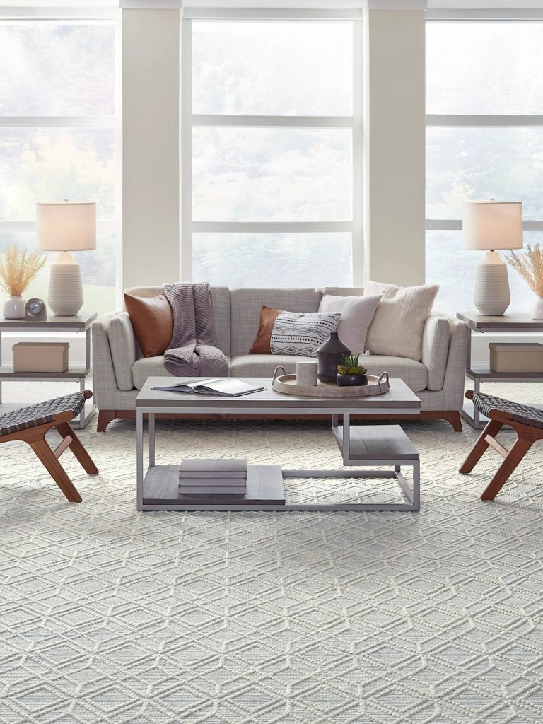 A light gray and white patterned carpet with gray and wood furniture for our spring carpet inspo.