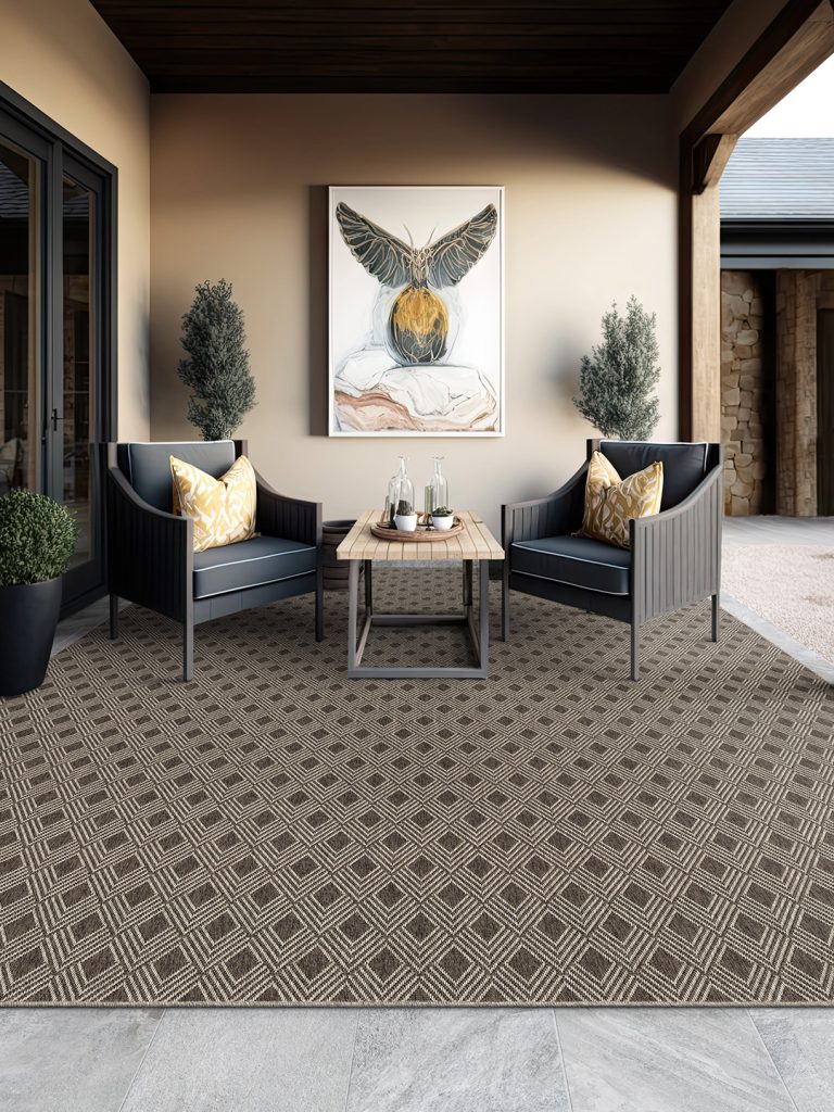A brown diamond patterned outdoor rug with dark furniture in an outdoor living room.