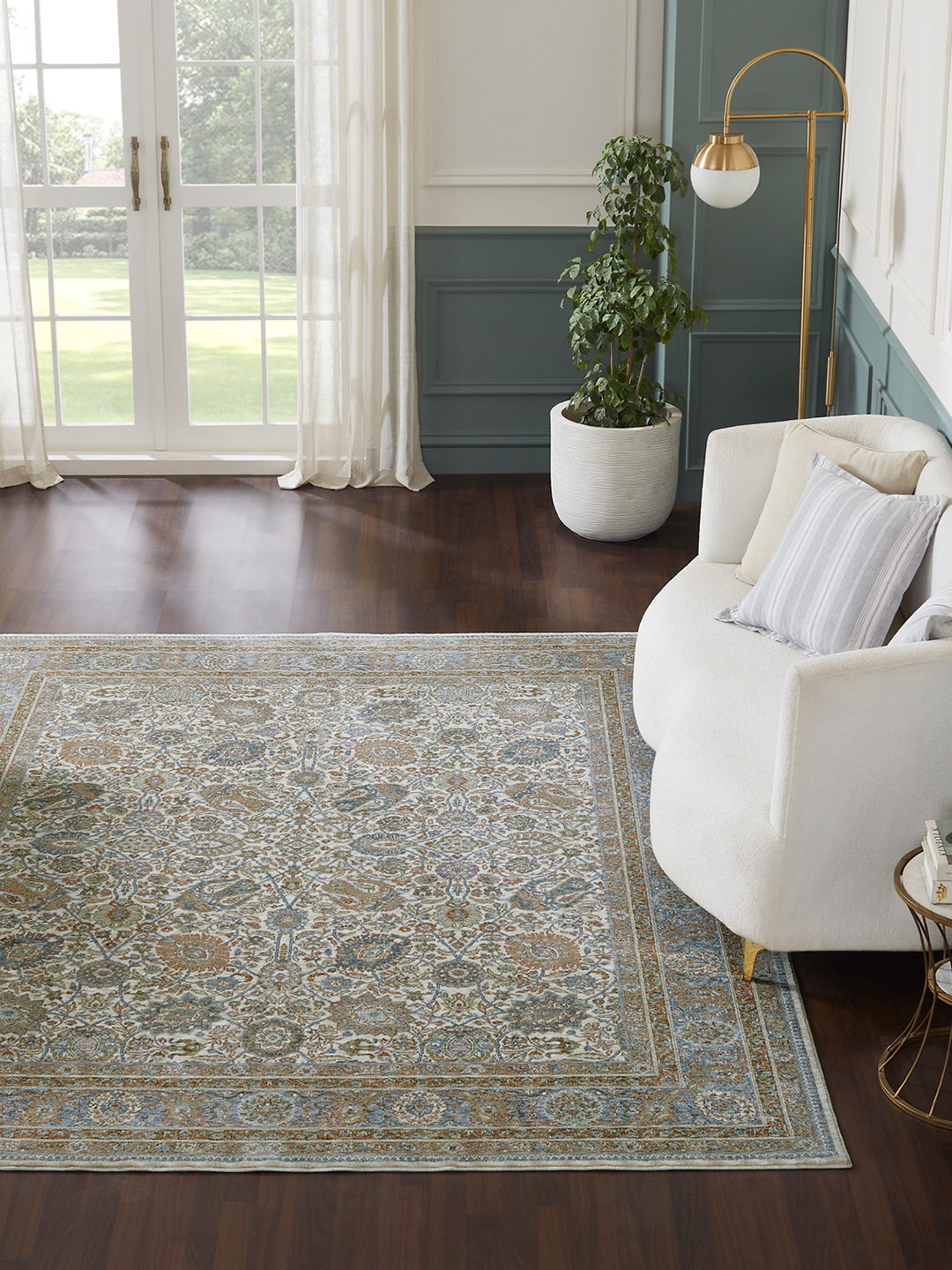 A multicolored patterned machine-made rug in a living room setting.