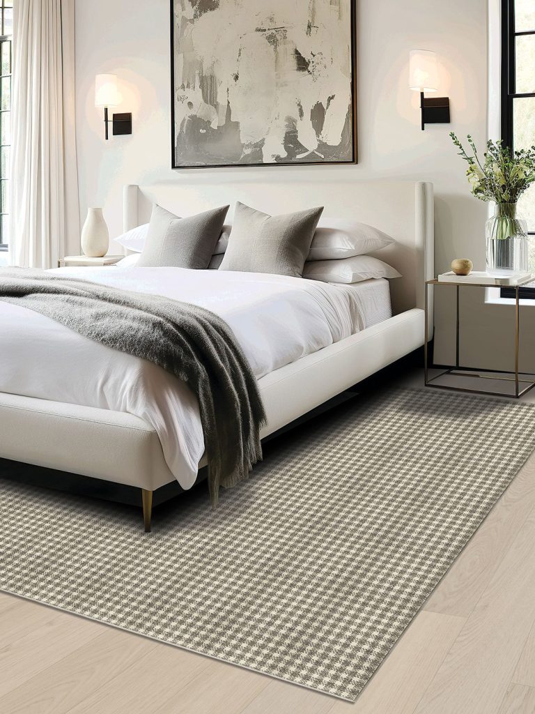A checkered residential carpet in a neutral bedroom setting.