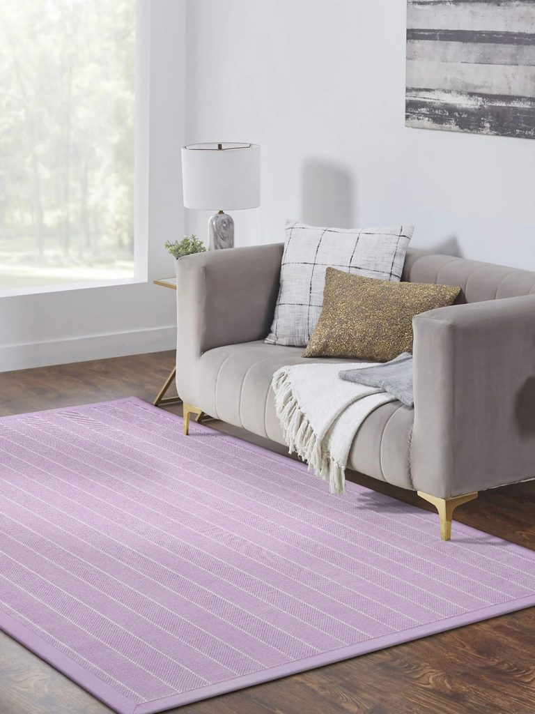 A small bright purple residential carpet with thin white lines in a neutral living room setting.