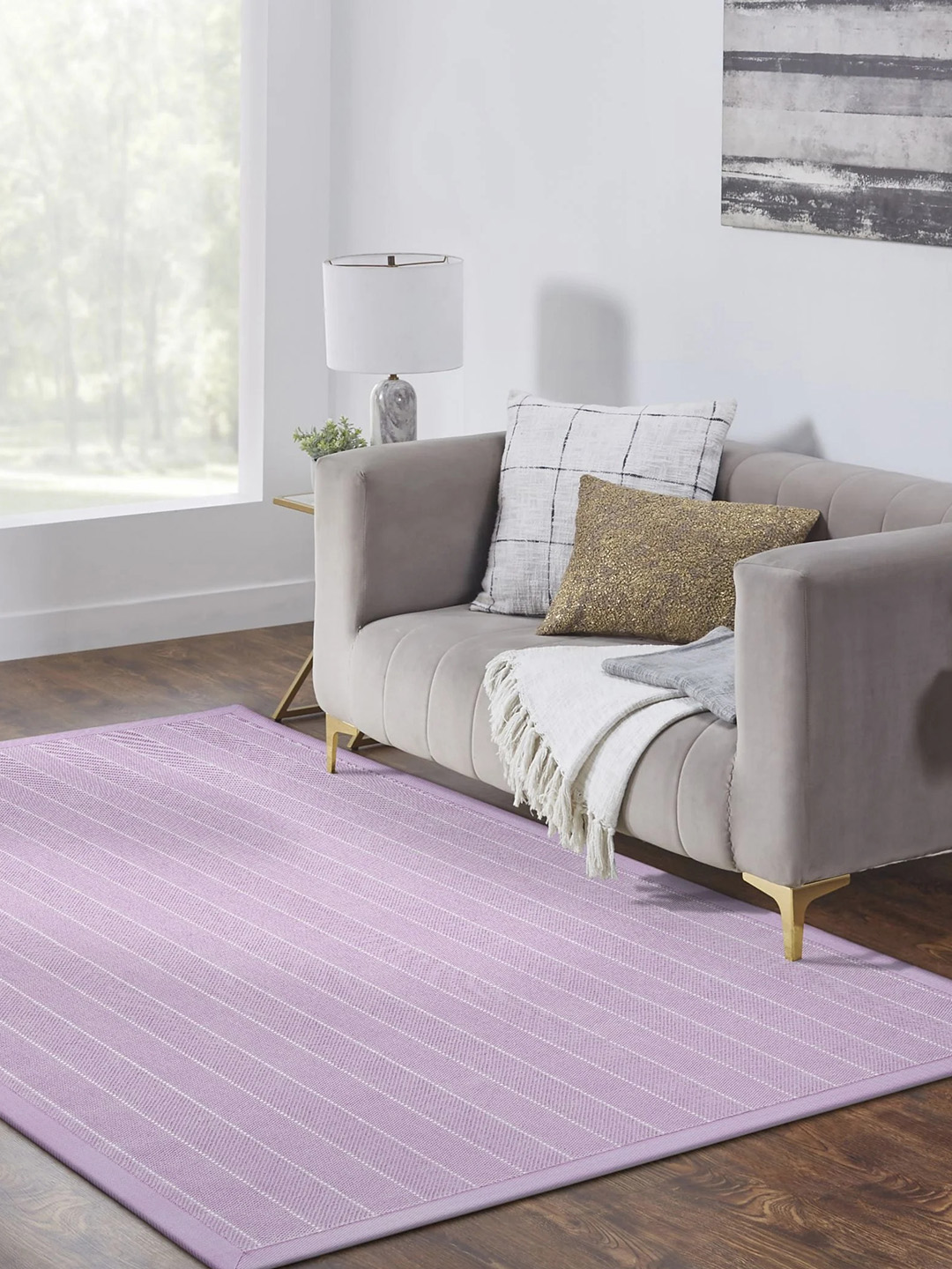 A small bright purple residential carpet with thin white lines in a neutral living room setting.