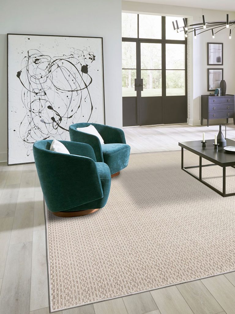 A light brown patterned residential carpet beneath teal chairs in a living room setting.