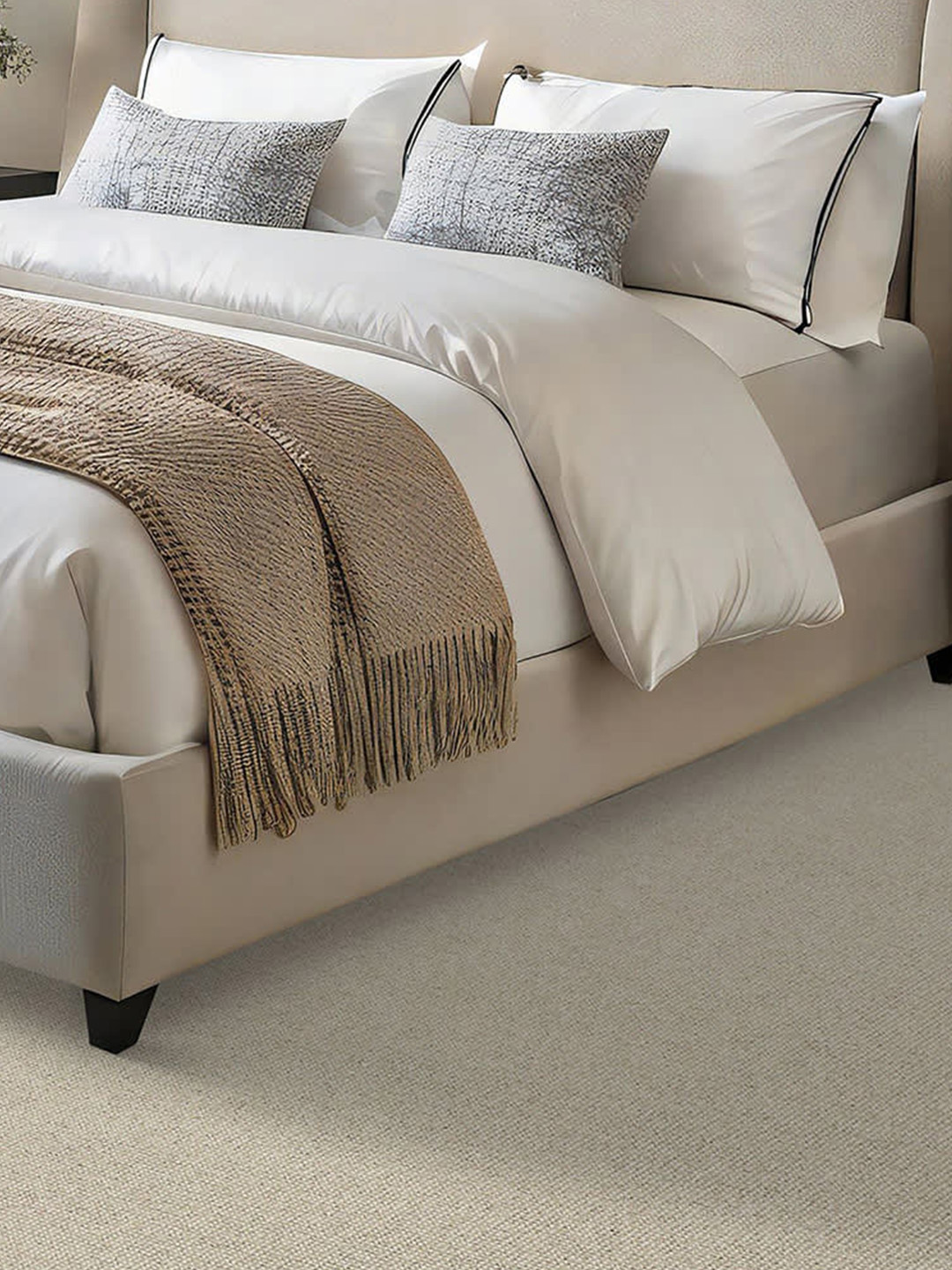 Light colored wool carpet with a large, white and beige bed.