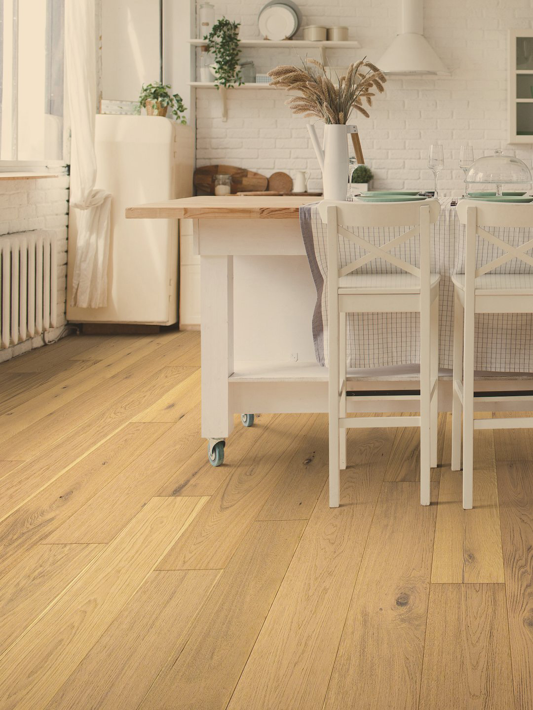 Light colored hardwood flooring a kitchen setting.