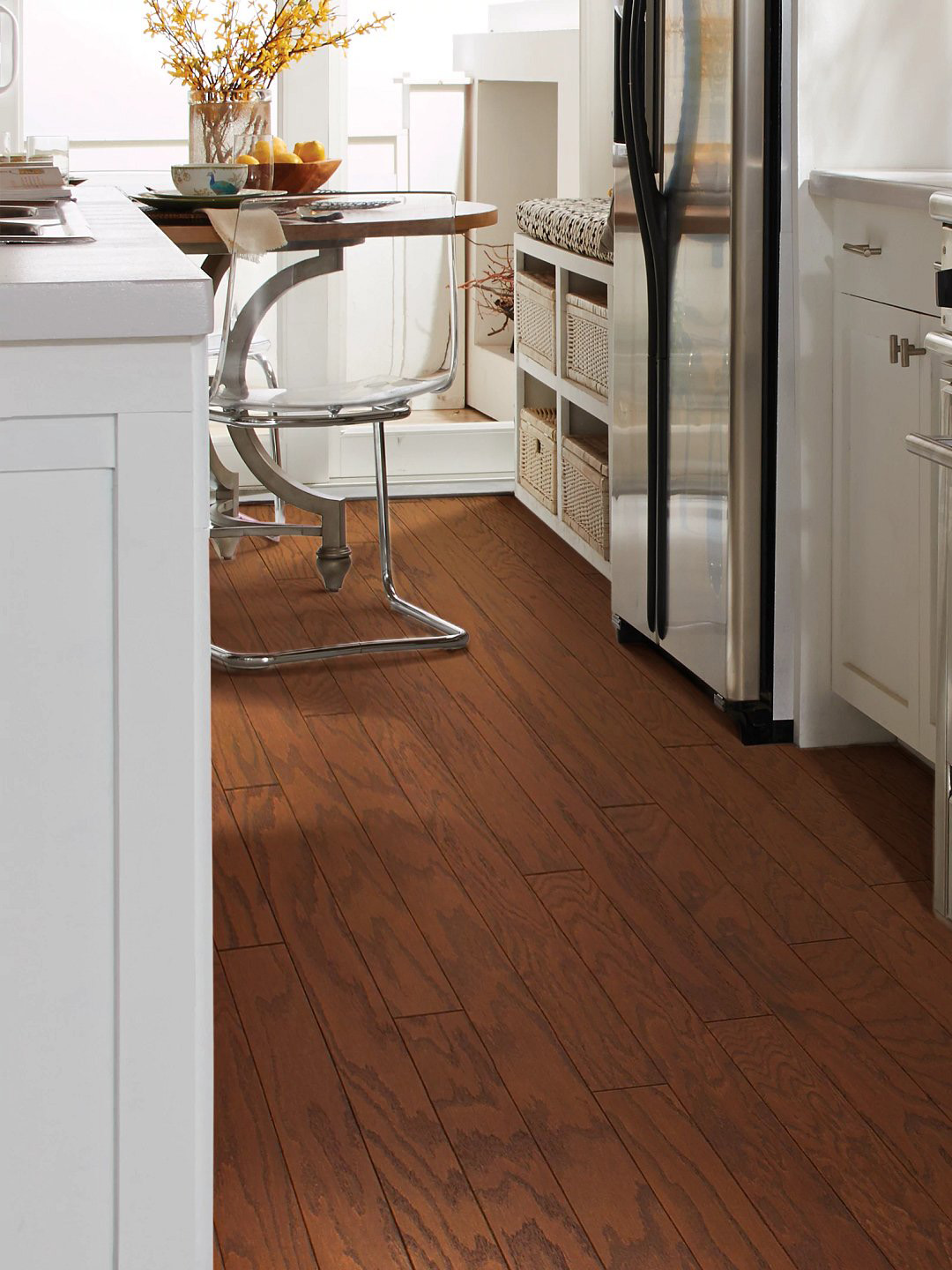 Warm, reddish hardwood flooring in a kitchen setting.