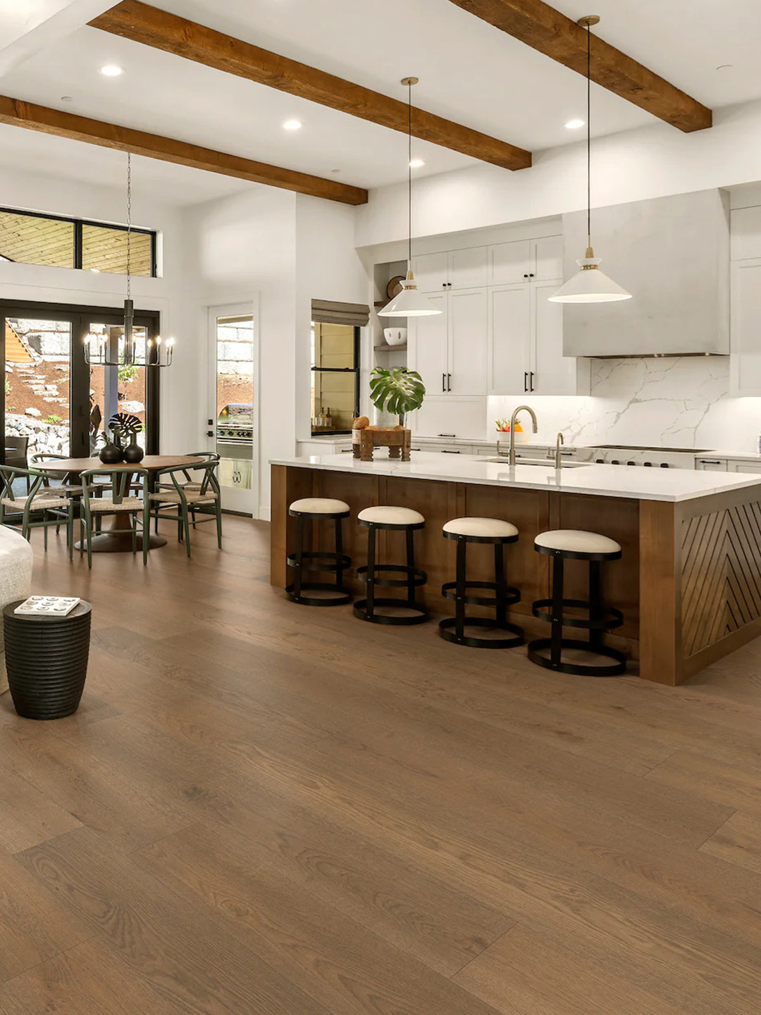 Brown hardwood flooring in a large kitchen setting.