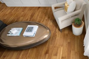 Multishade hardwood flooring beneath a metallic coffee table and a white chair.