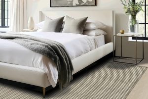 A checkered Karastan Black Label rug beneath a bed to highlight our Summer Sizzler Rug Sale.