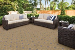 A gold and blue diamond patterned carpet in an outdoor patio setting.