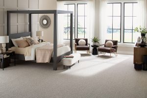 A light colored wool broadloom carpet (Cassian by Karastan Black Label) a bedroom setting.