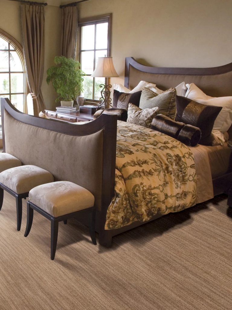 A brown Masland carpet with light brown striations in a bedroom setting.
