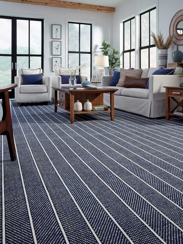 A blue and white striped Masland carpet in a living room setting.