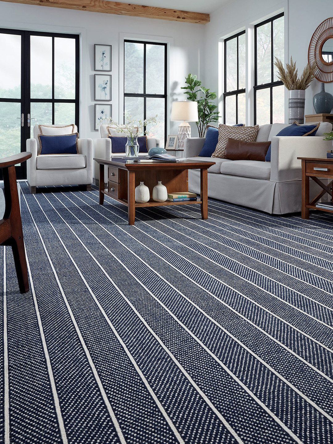 A blue and white striped Masland carpet in a living room setting.