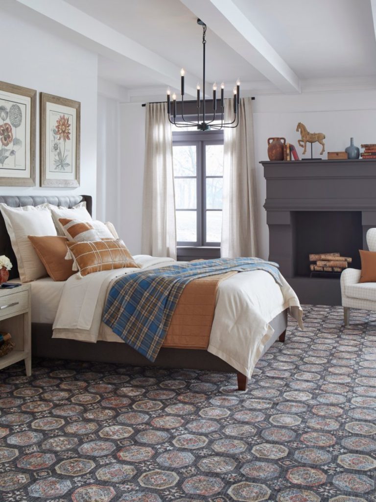 An oriental geometric patterned carpet by Masland in a bedroom setting 