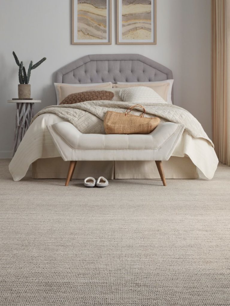 A natural colored carpet by Masland with punctuations of color in a bedroom setting 